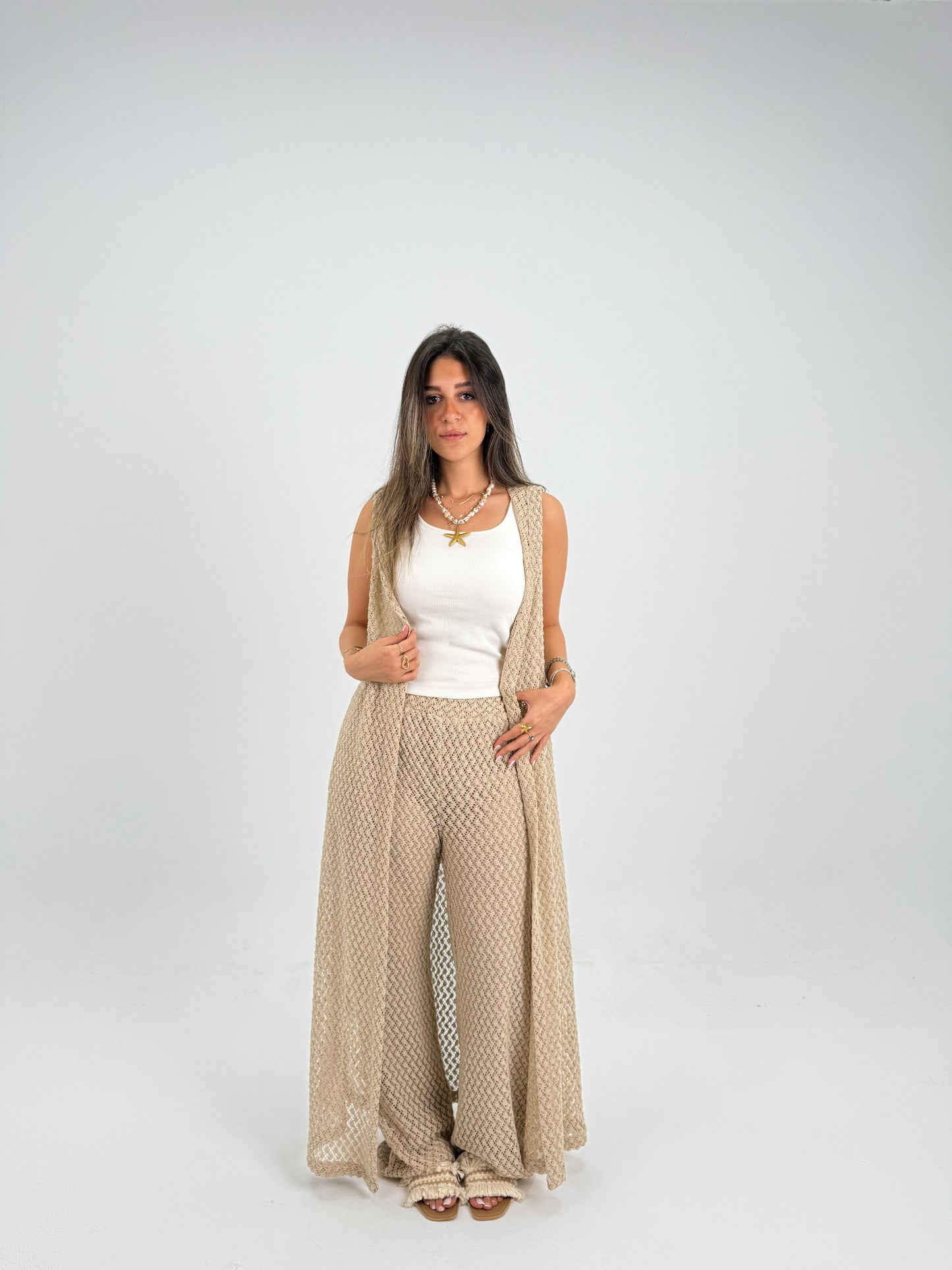 Hooded crochet long vest in beige With knitted pants 