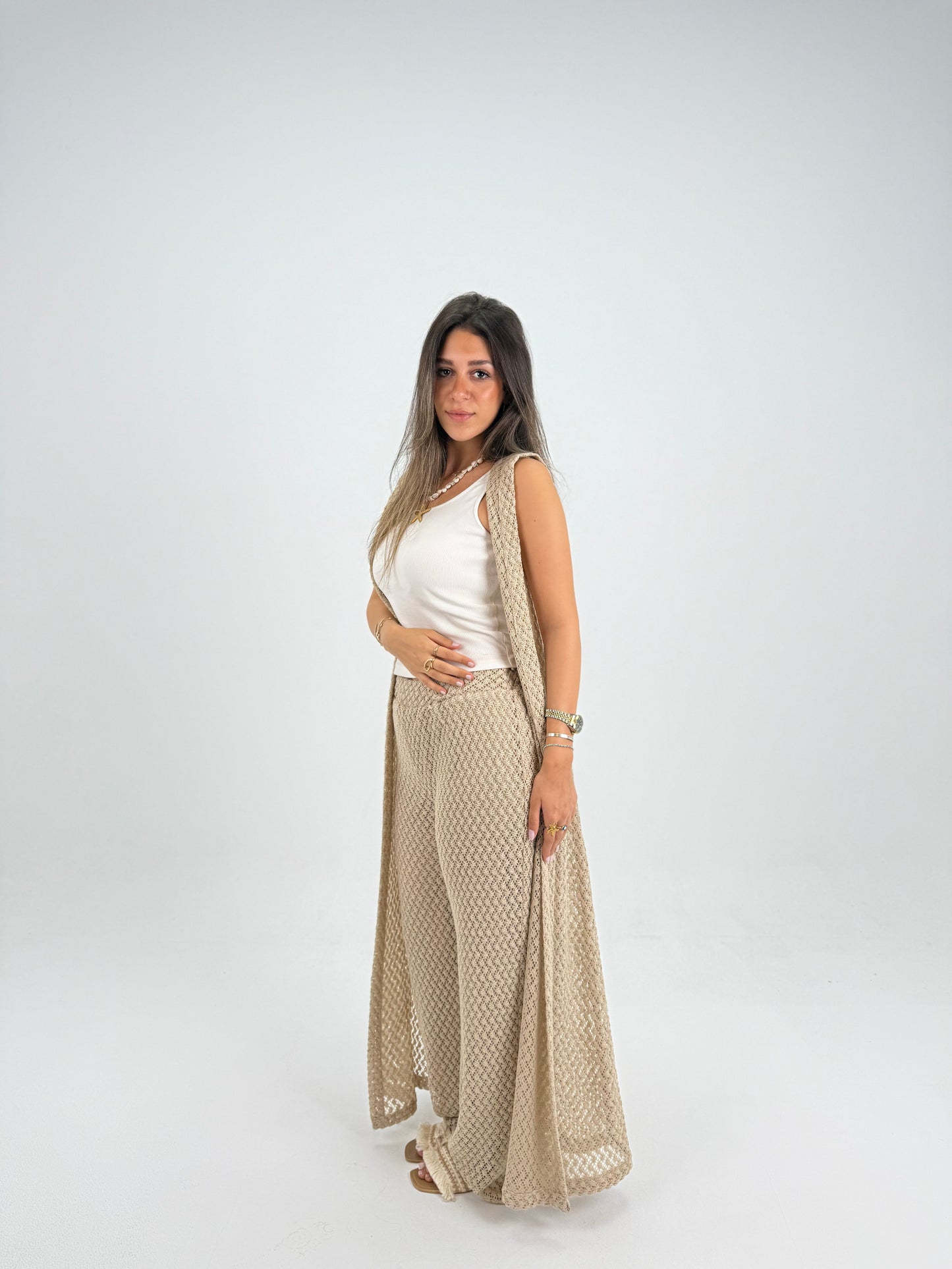 Hooded crochet long vest in beige With knitted pants 
