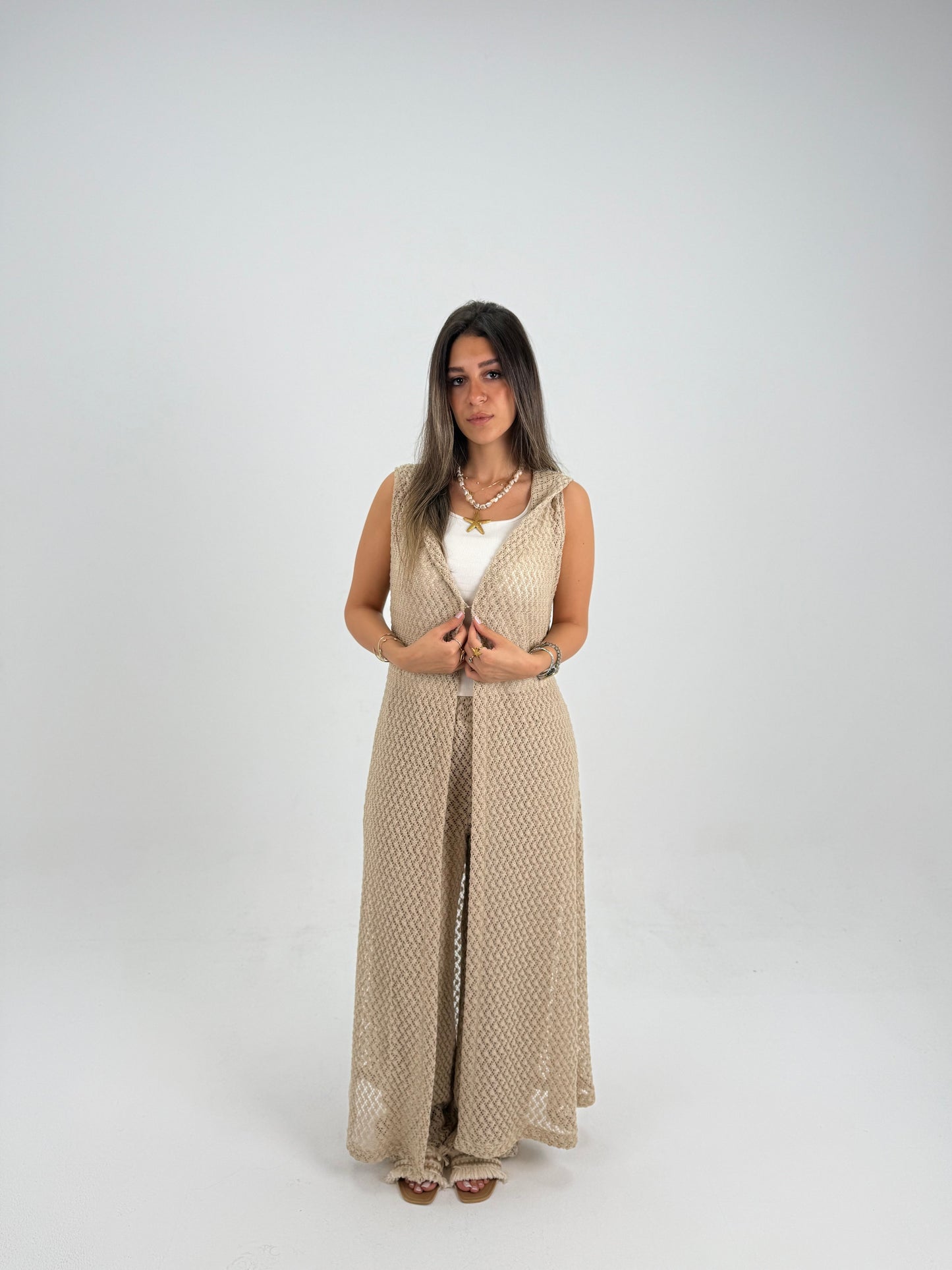 Hooded crochet long vest in beige With knitted pants 