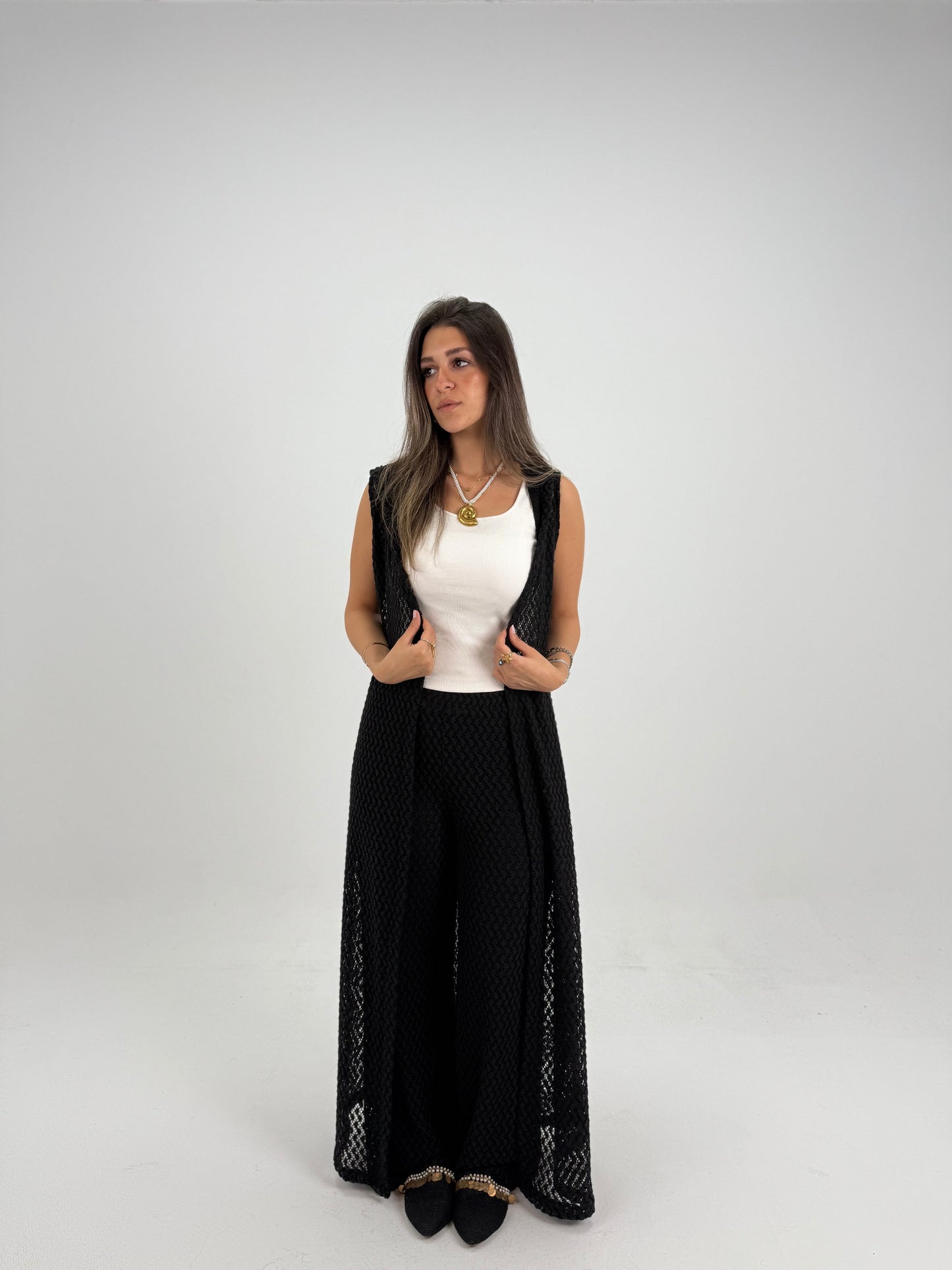 Hooded crochet long vest in black With knitted pants 